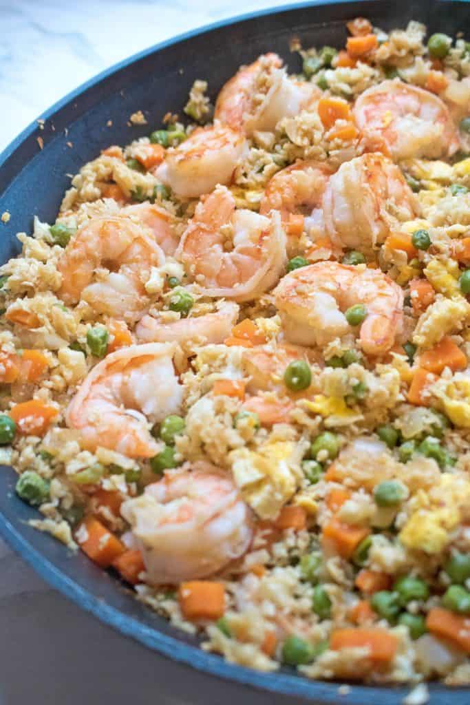 cauliflower shrimp fried rice cooked in a large saute pan