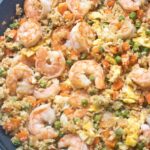 cauliflower shrimp fried rice in a large saute pan cooked