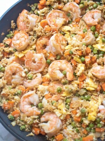 cauliflower shrimp fried rice in a large saute pan cooked