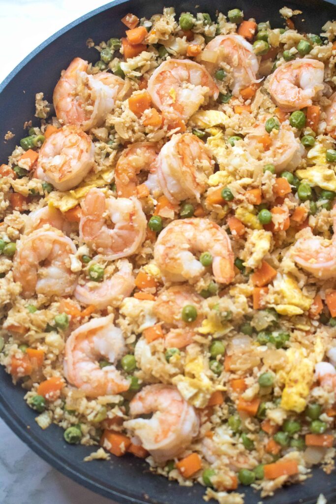 Cooked cauliflower shrimp fried rice in a large saute pan