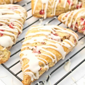 glazed scones with strawberries on a cooling rack