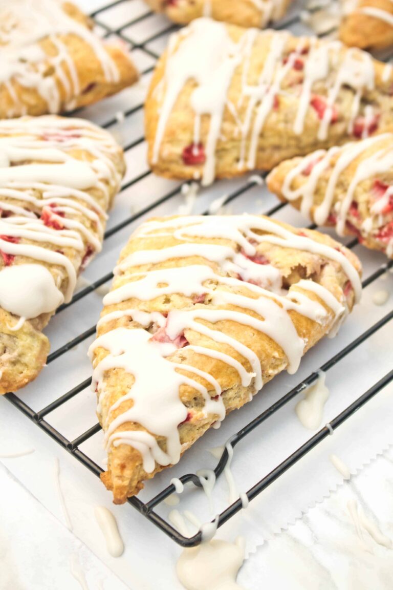 glazed scones with strawberries on a cooling rack