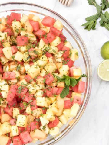 a bowl of pineapple, watermelon, and mint.