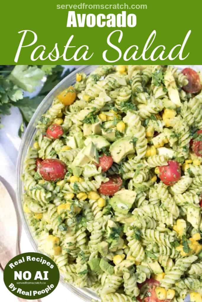 an overhead of a green pasta salad with tomatoes, corn, and avocados with Pinterest pin text and NO AI sticker.