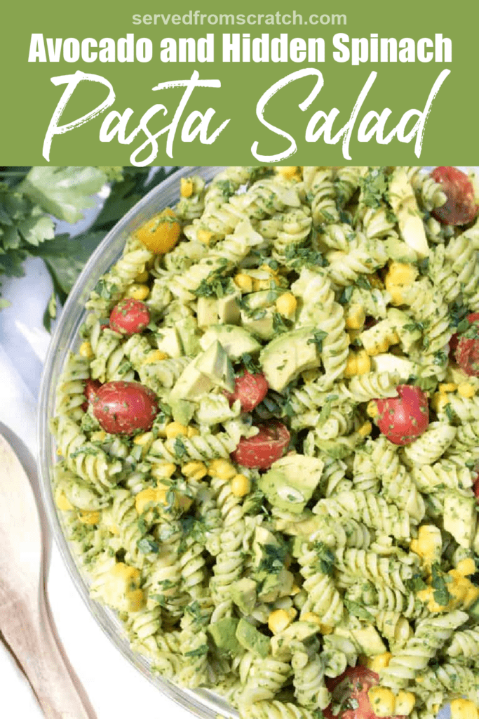 overhead of pasta salad with creamy avocado and tomatoes and corn with PInterest pin text.