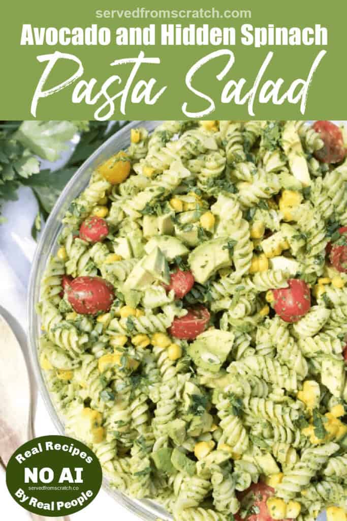 an overhead of a green pasta salad with tomatoes, corn, and avocados with Pinterest pin text and NO AI sticker.