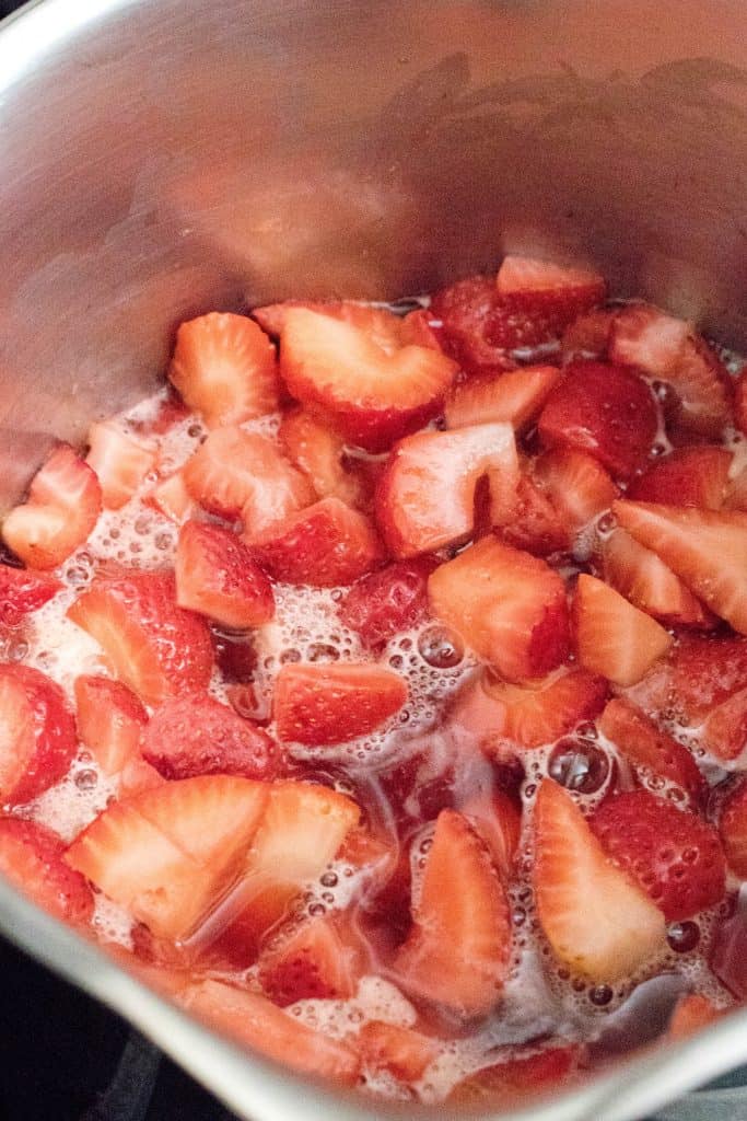a pan with cooking strawberries.