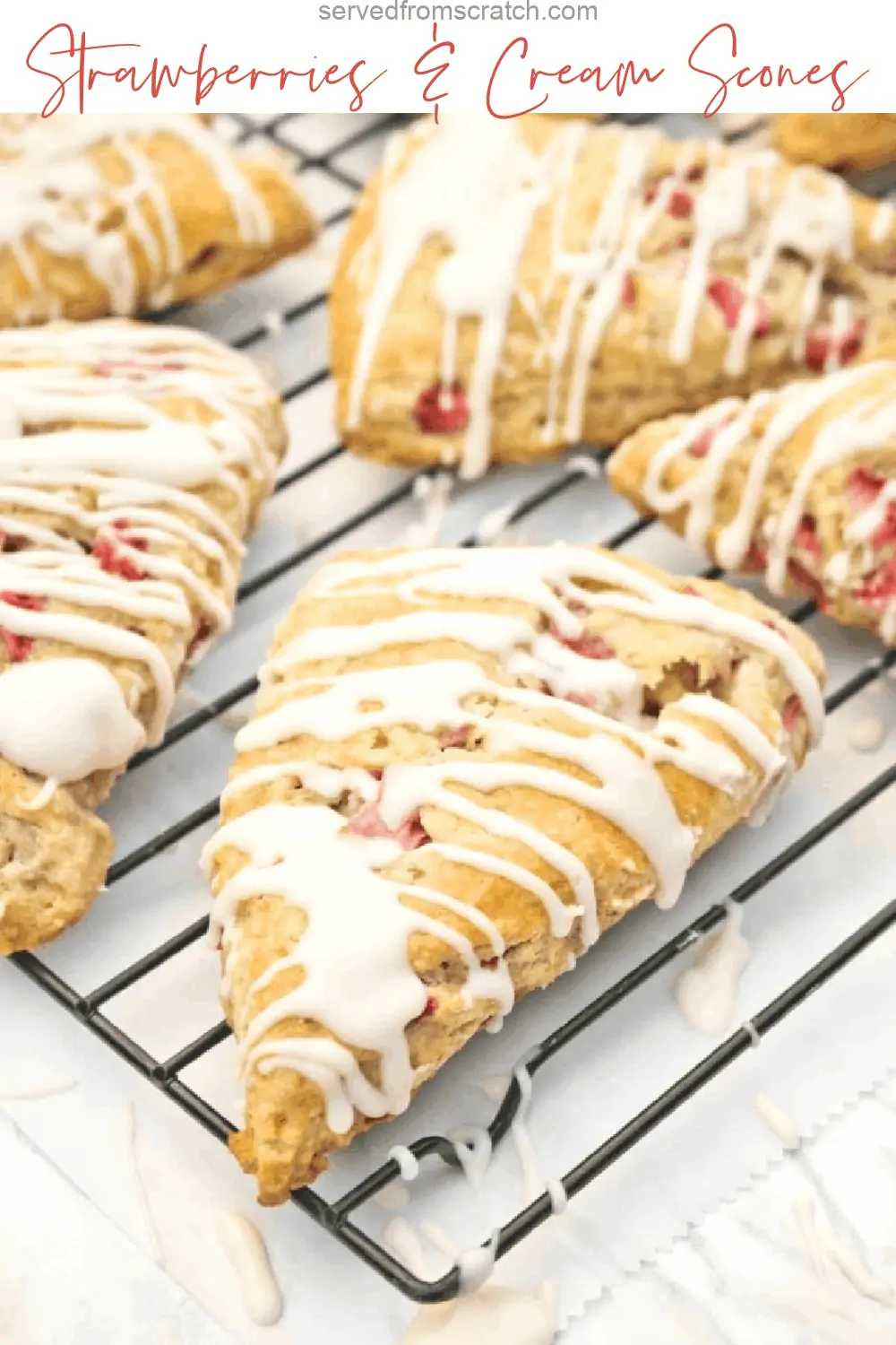 glazed scones with strawberries on a cooling rack.