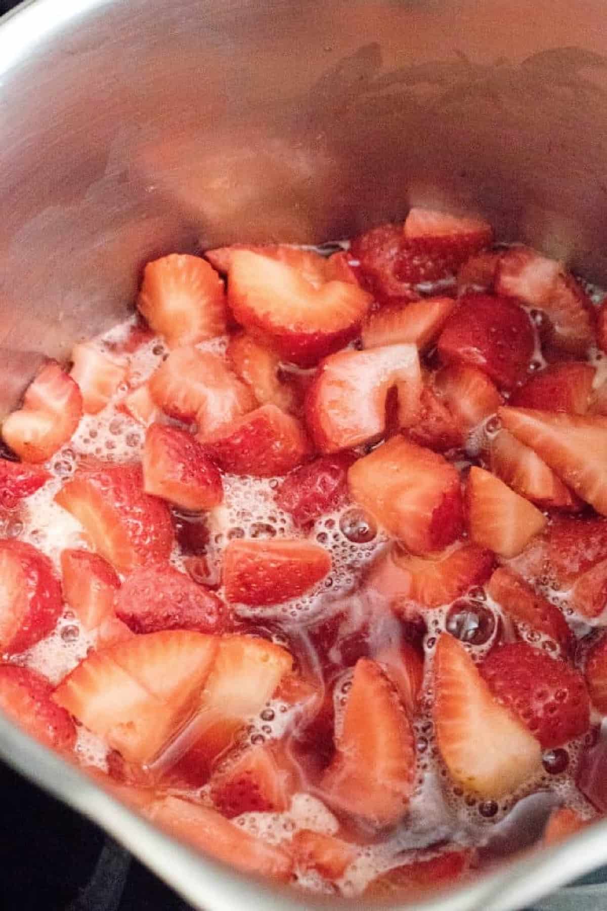 strawberries cooking in a pot.