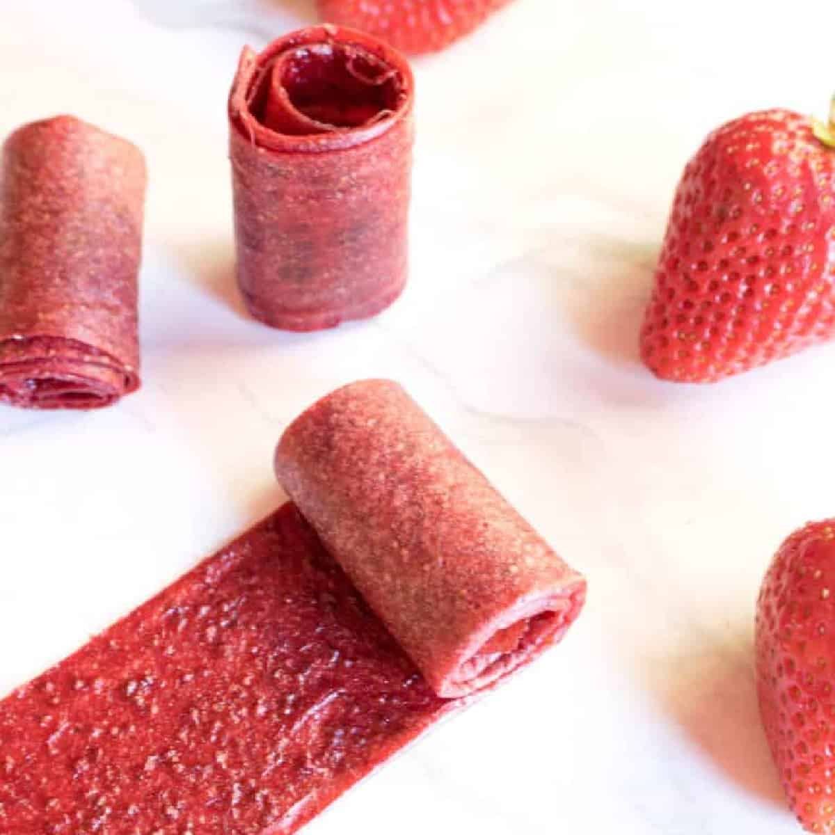 some rolled up strawberry fruit roll ups.