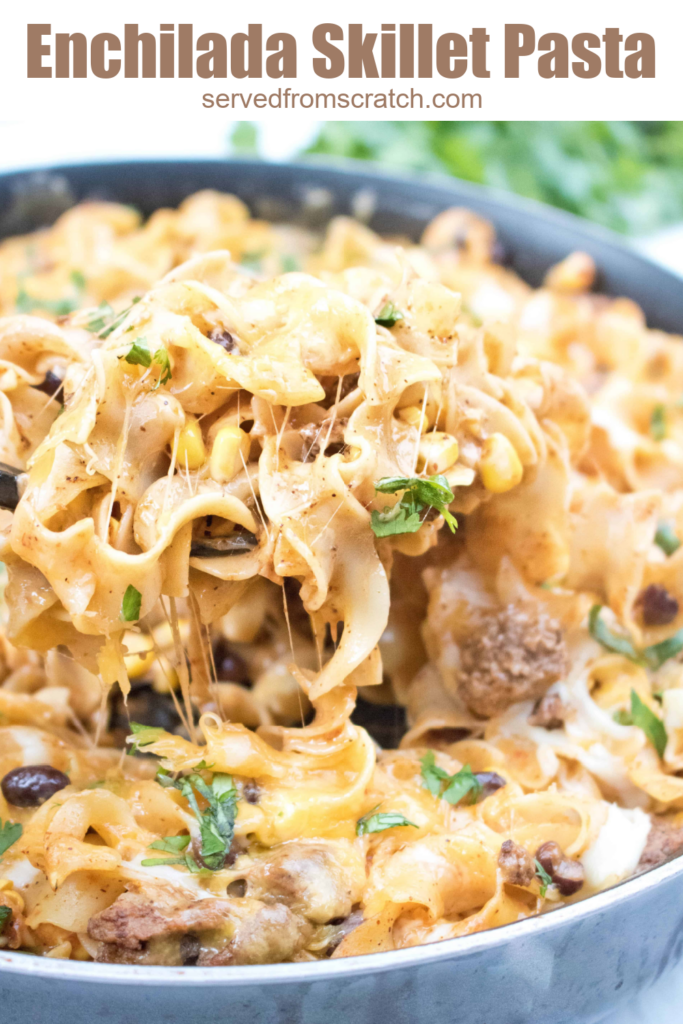 a pan of cheesy pasta with a spoonful being scooped out with Pinterest pin text.