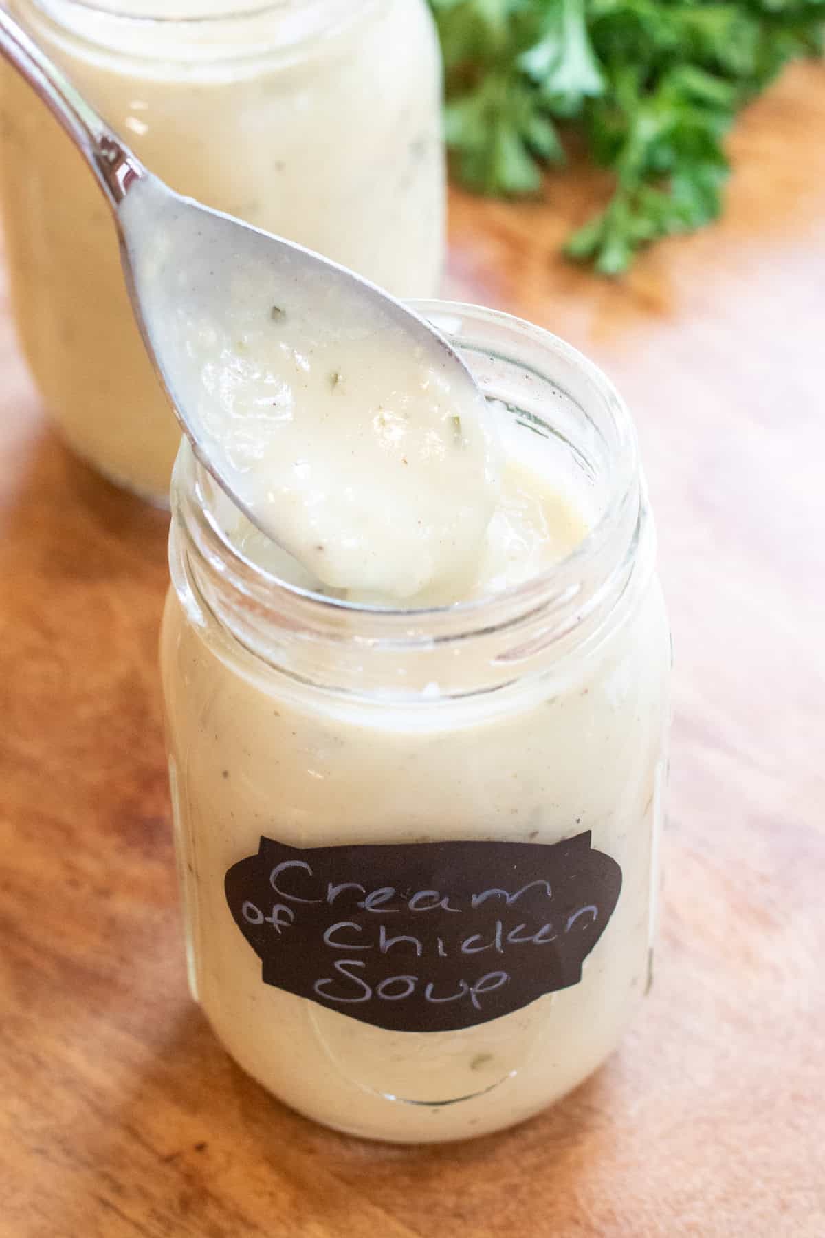 a mason jar of condensed cream of chicken soup with a spoon.