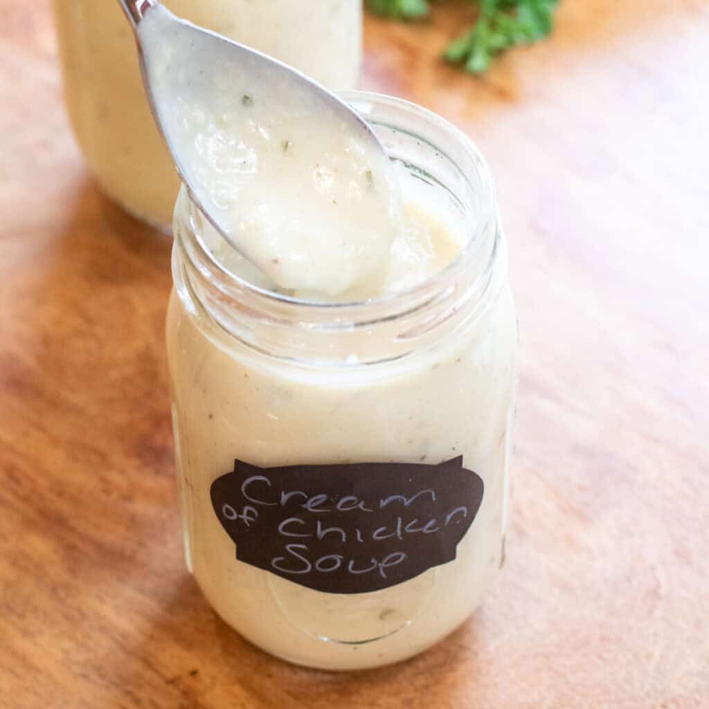 a mason jar of condensed cream of chicken soup with a spoon.
