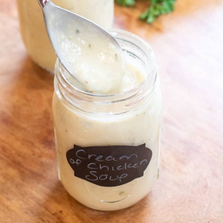 a mason jar of condensed cream of chicken soup with a spoon.