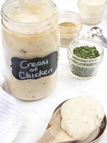 a mason jar of cream of chicken soup with a wooden spoon