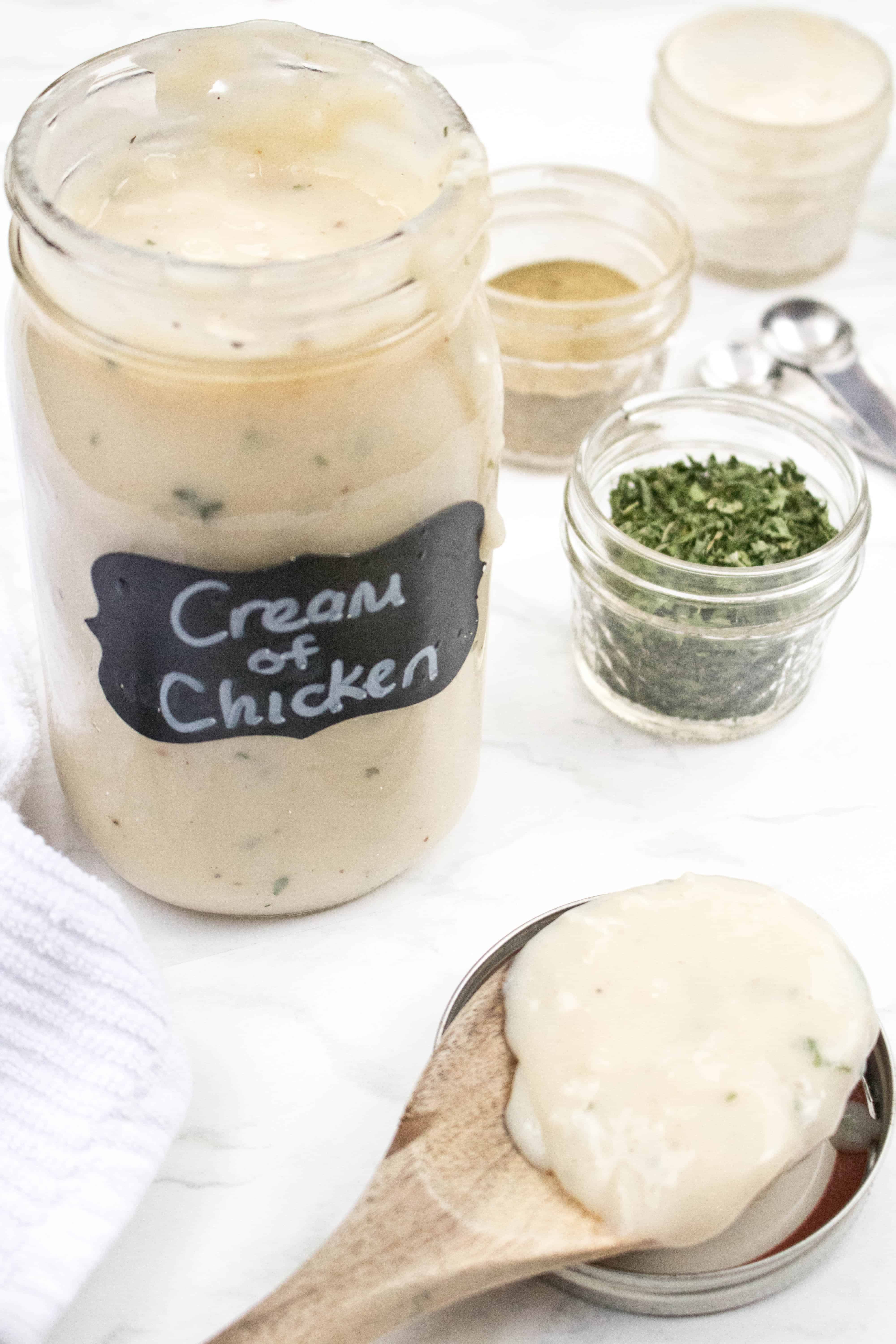 a mason jar of cream of chicken soup with a wooden spoon