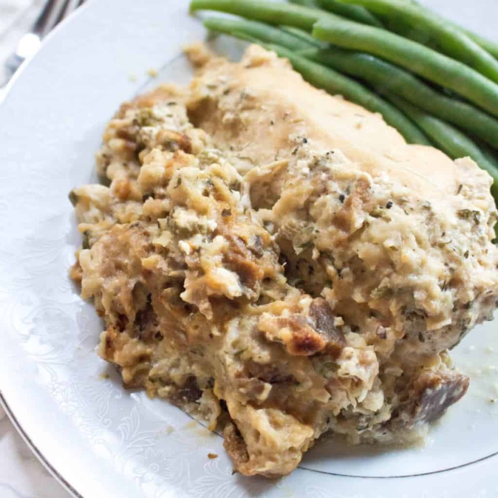 a plate with stuffing and chicken and green beans.