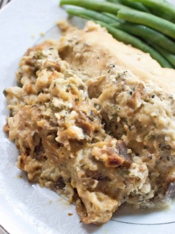 a plate with stuffing and chicken and green beans.