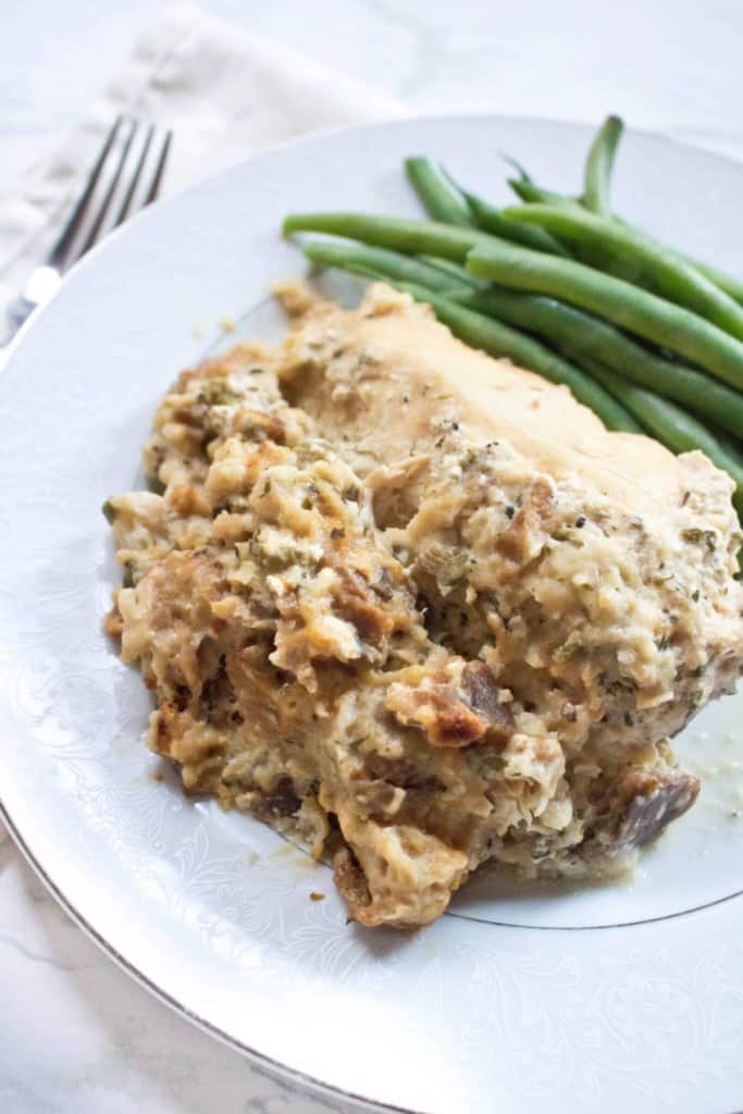 a plate with stuffing and chicken and green beans.