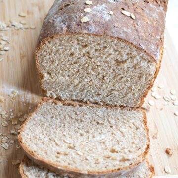 a loaf of whole wheat bread sliced on a cutting board