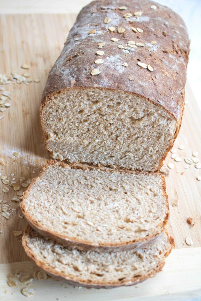 a loaf of whole wheat bread sliced on a cutting board