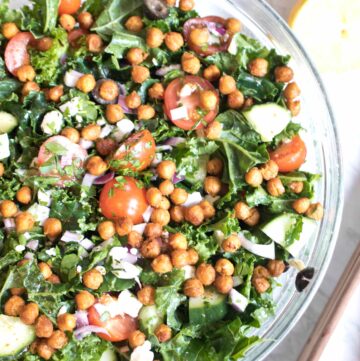 bowl with kale, tomatoes, cucumbers, feta, and chickpeas