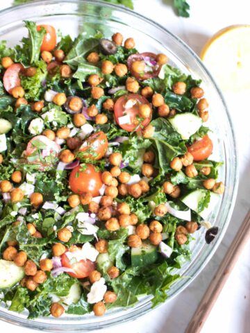 bowl with kale, tomatoes, cucumbers, feta, and chickpeas