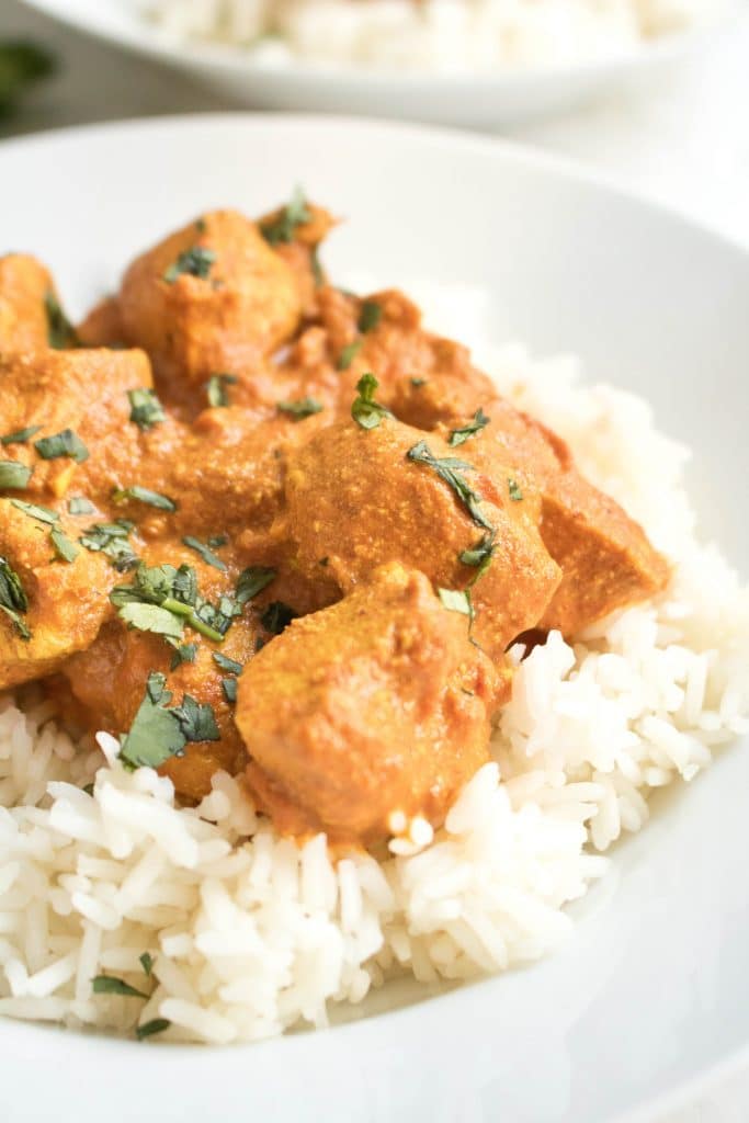 Chicken Tikka Masala on a bed of white rice in a bowl