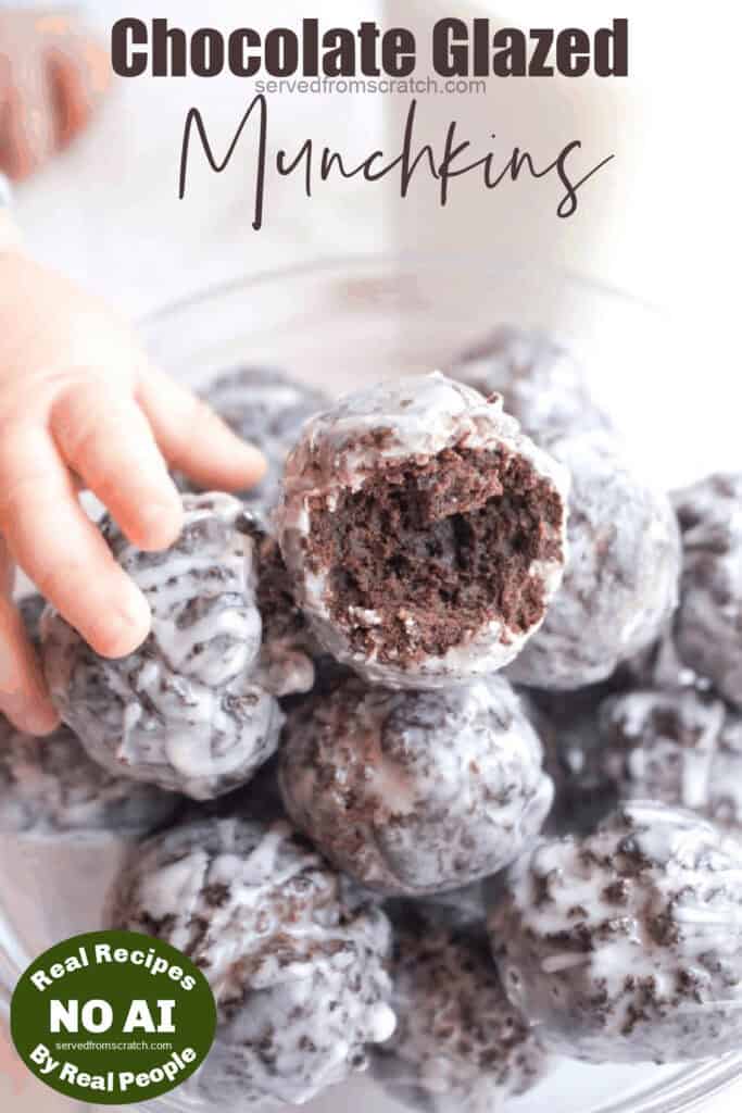 a tiny hand grabbing a chocolate munchkin from a bowl with Pinterest Pin text and NO AI sticker.