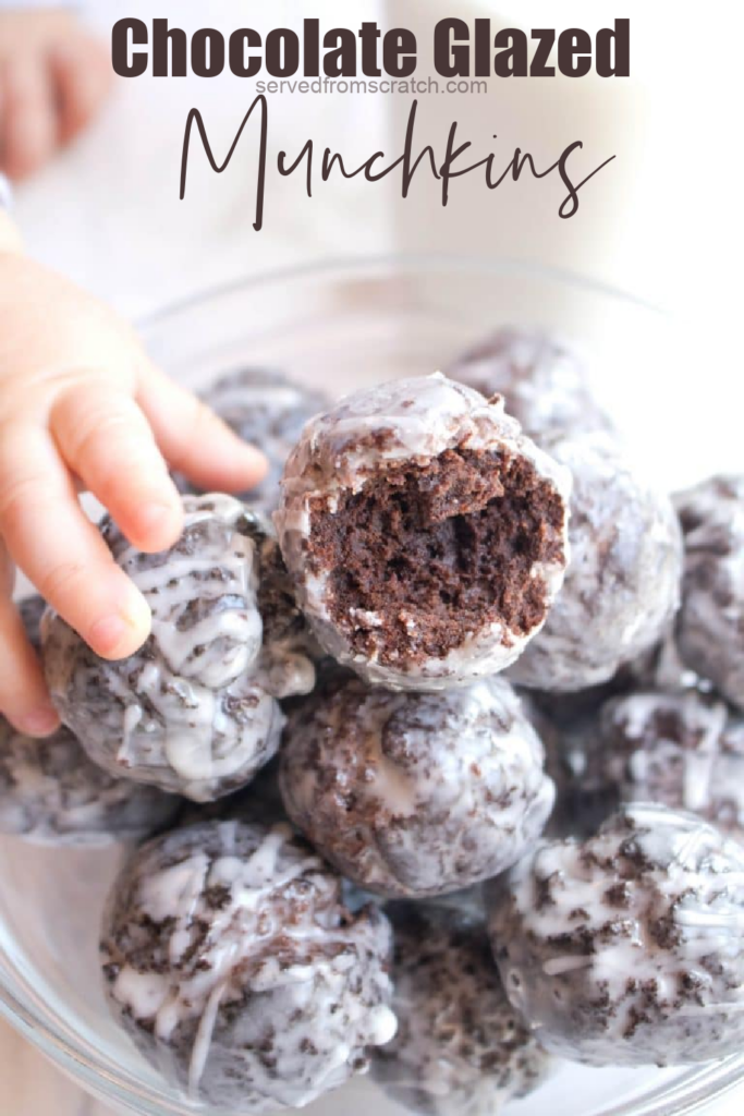 a bowl of glazed chocolate donuts one with a bite taken out and a little hand and pinterest text.