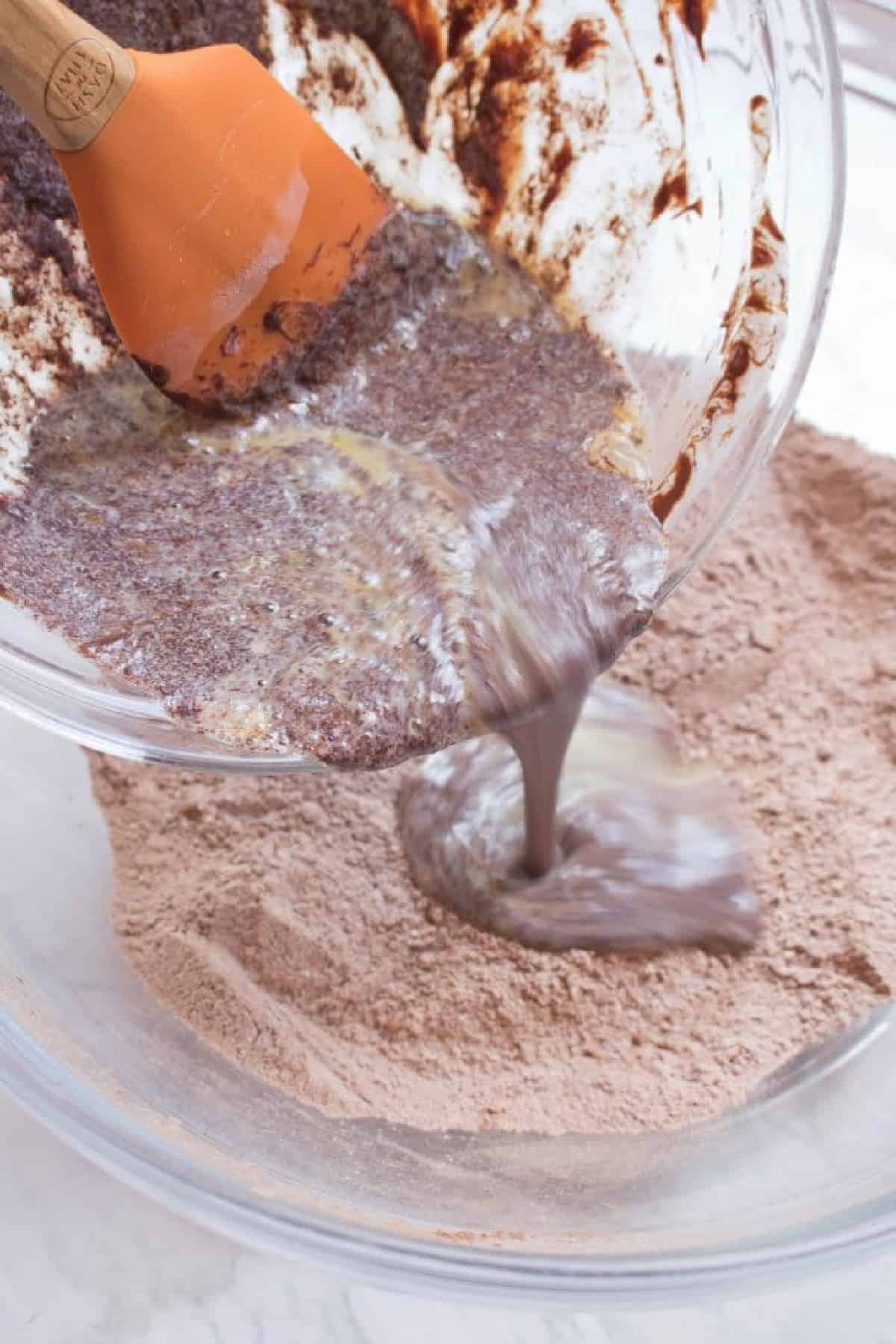 chocolate being poured into a bowl of powdered chocolate.