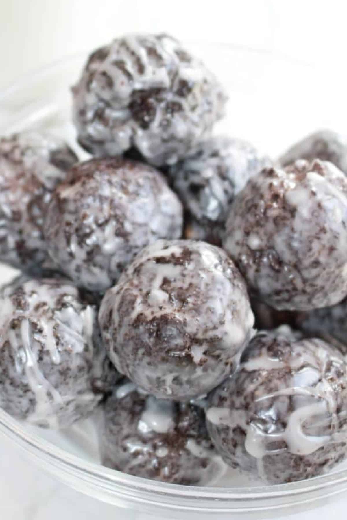 a bowl of glazed chocolate munchkins.