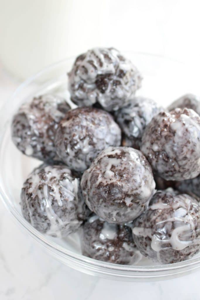 glazed chocolate donut holes in a bowl.