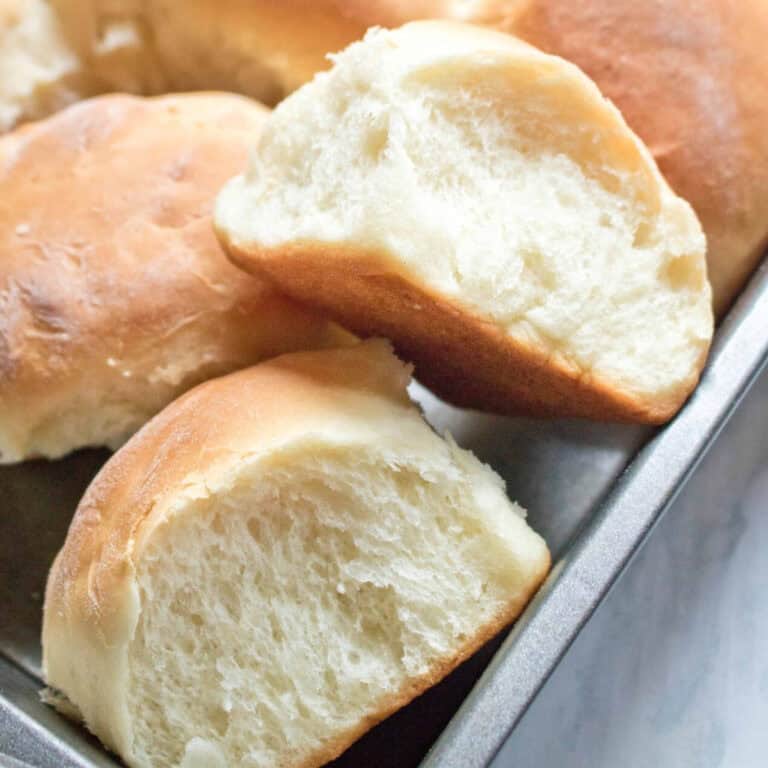 two dinner rolls pulled out of a pan.