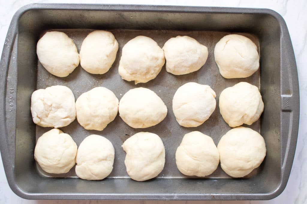 15 shaped balls in a baking pan.