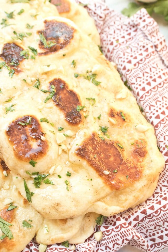 a plate of naan with butter and garlic.