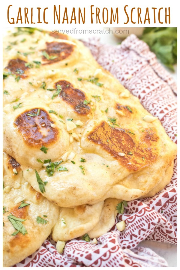 naan with melted butter and garlic on a red napkin.