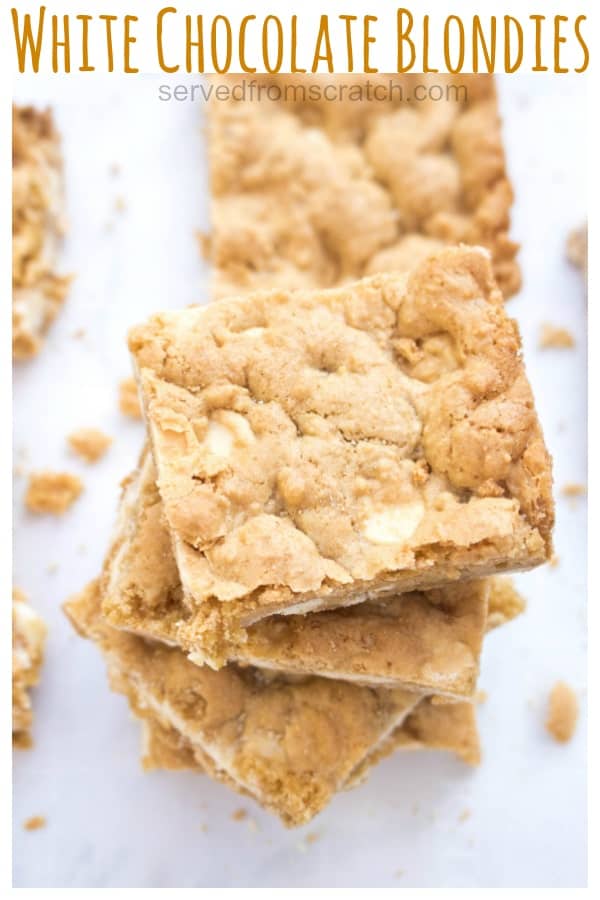 overhead of stacked blondies on parchment paper with Pinterest Pin text.