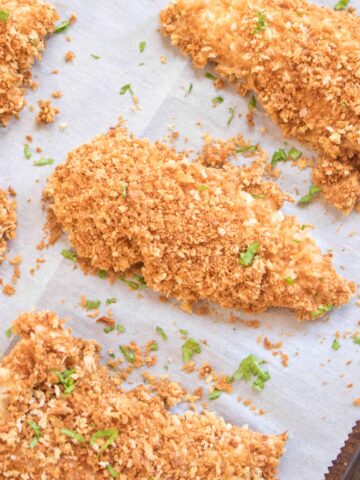 crispy baked panko crusted chicken tenders on parchment paper