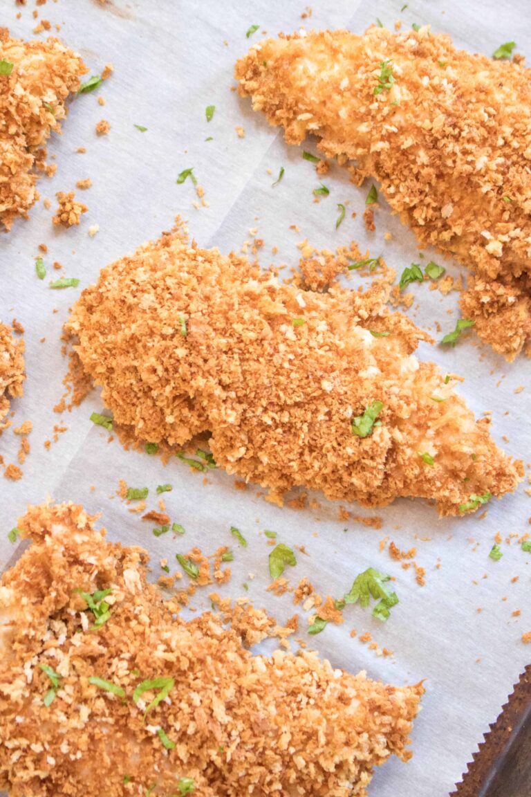 crispy baked panko crusted chicken tenders on parchment paper