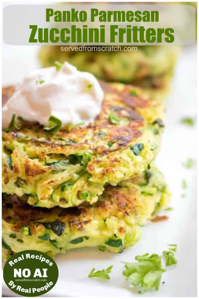a stack of cooked zucchini fritters with a dollop of sour cream on top with Pinterest pin text and NO AI sticker.
