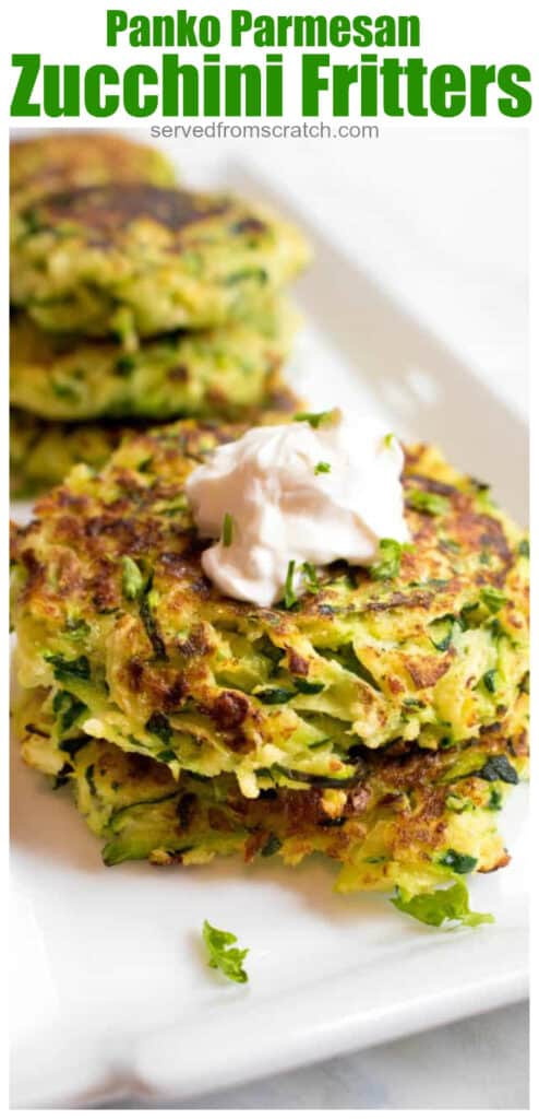 stacked cooked zucchini fritters topped with sour cream with Pinterest pin text.