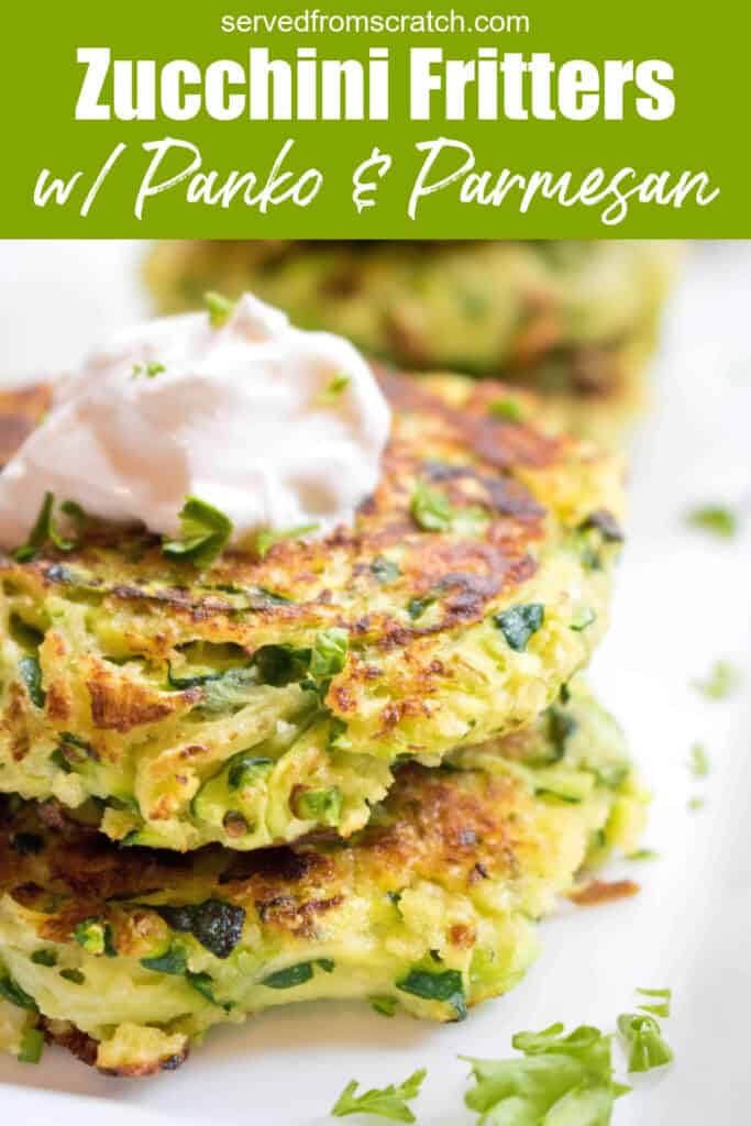 a close of up of stacked zucchini fritters topped with sour cream with Pinterest pin text.
