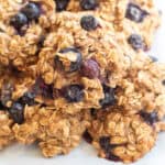 a close up of a plate of oatmeal cookies with blueberries.