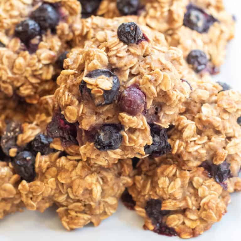 a close up of a plate of oatmeal cookies with blueberries.