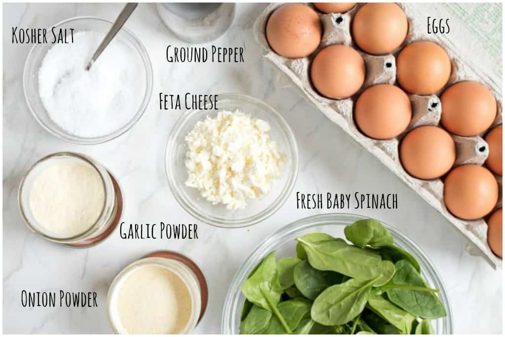 eggs, spinach, feta, onion and garlic powder, salt, and pepper on the counter.