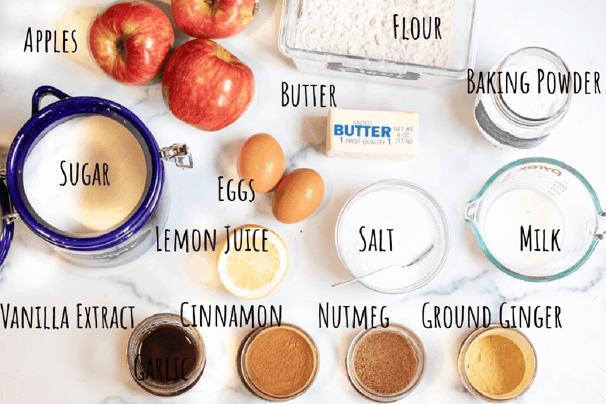 apples, sugar, spices, salt, lemon, butter, flour, baking powder, and milk on counter.