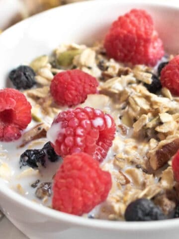 a bowl of muesli with fresh fruit on top.