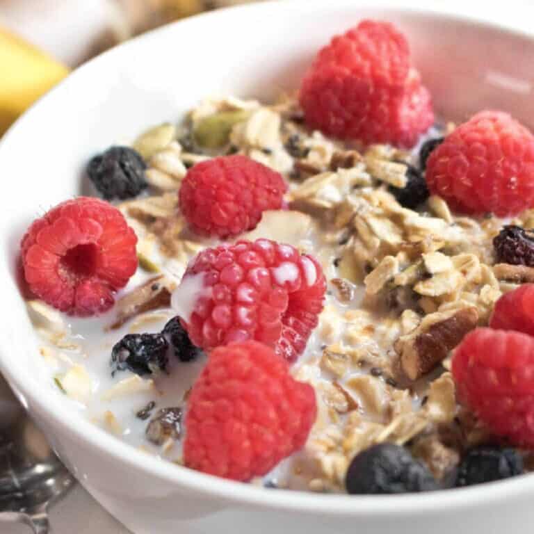 a bowl of muesli with fresh fruit on top.