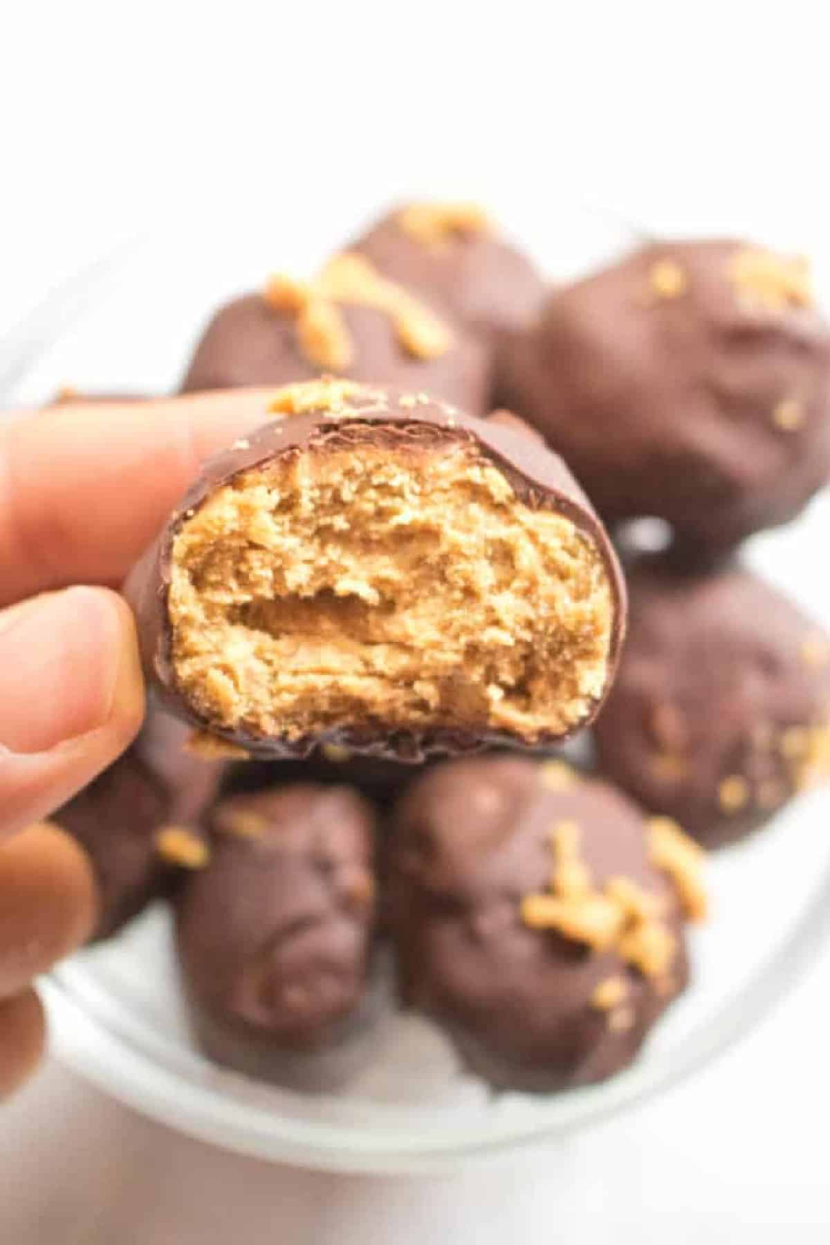 a hand holding a butterfinger bite.